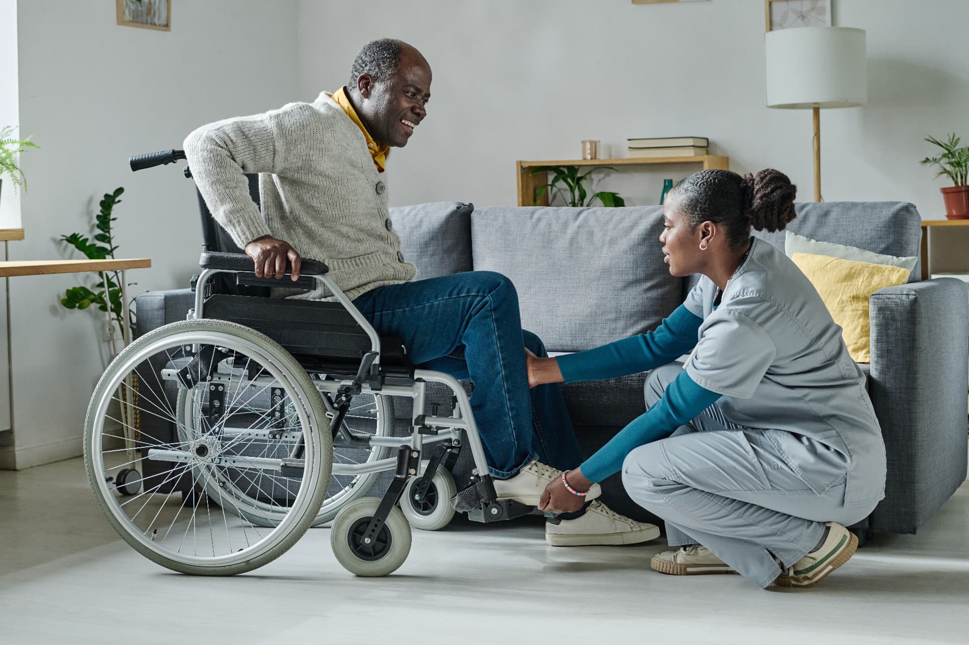 A carer supporting an elderly patient at home