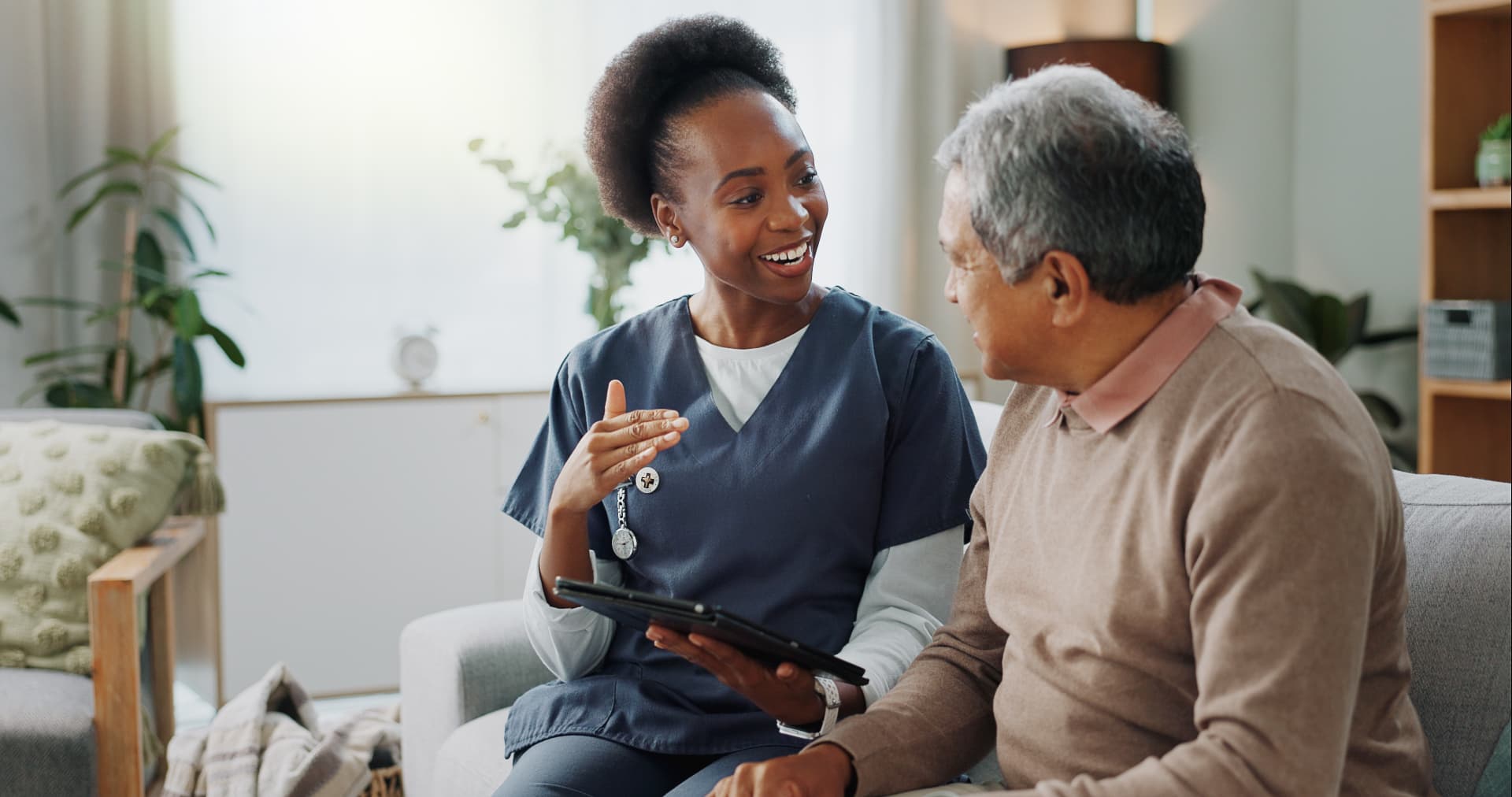 Healthcare professional consulting with elderly patient at home